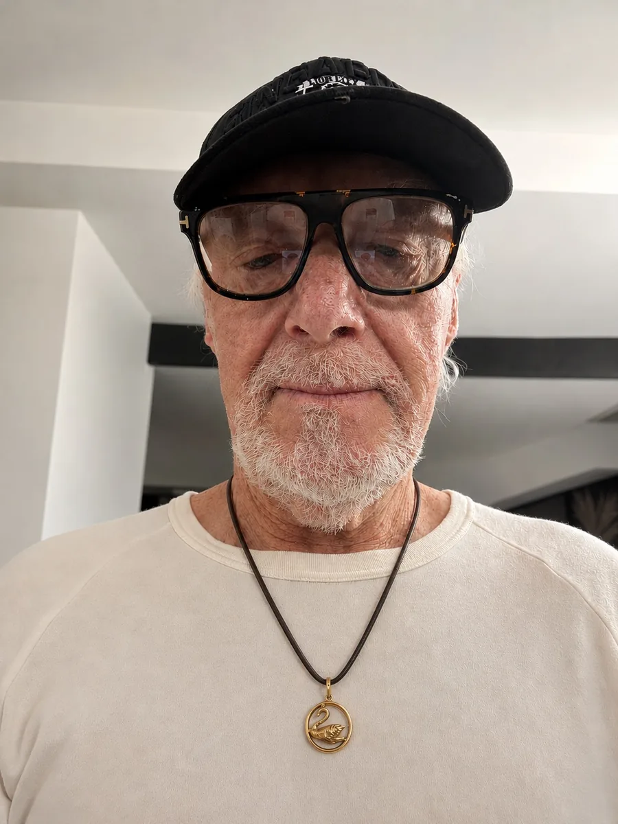 Wayne McCrae wearing the Swan in the Circle silver pendant